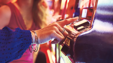people cheering at slot machine