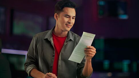 Man writing his picks down at the Sportsbook.