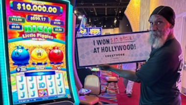 A Guest holding a sign that says "I Won $15,890.21 at Hollywood!"