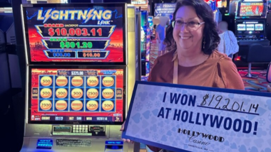 Picture of Virginia holding a sign saying she won $19,201