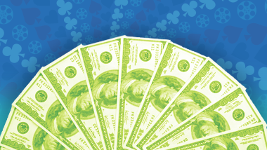 A fan of money tinted light green on a blue background