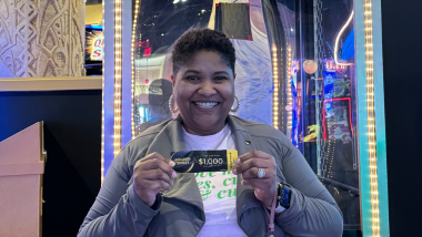 Winner holding up her winning golden ticket